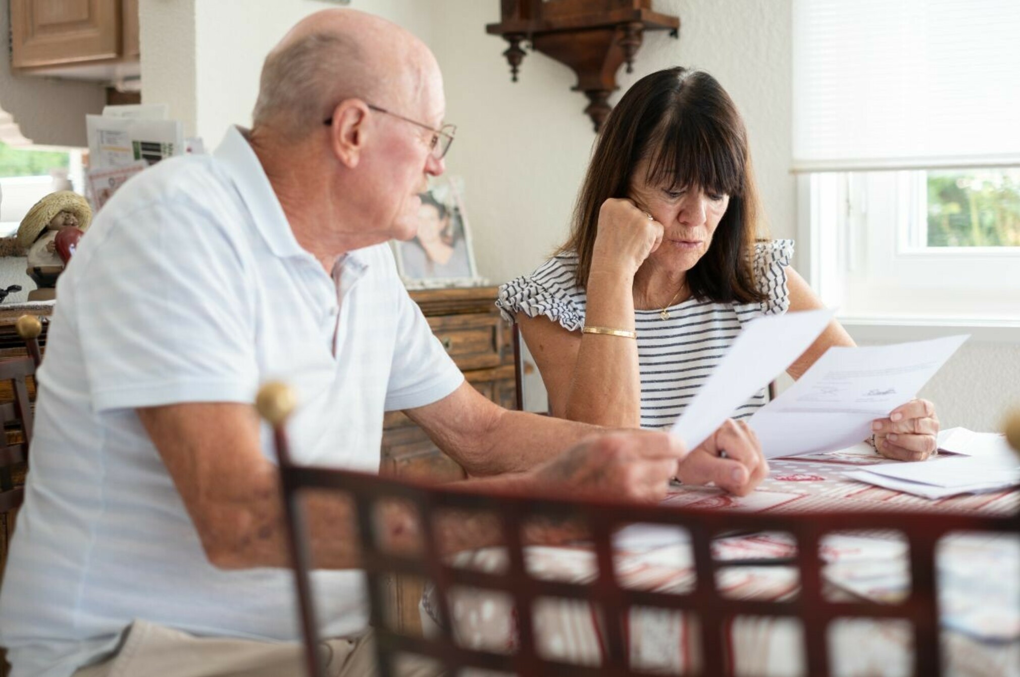 Consumer nz website promo image senior couple sitting at home table managing insurance