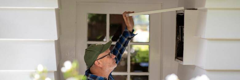 Image of a man opening circuit box