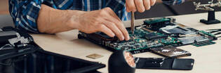 man repairing a laptop