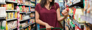 Woman looking at food product label