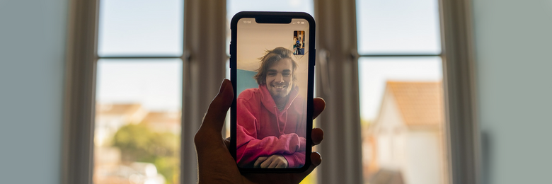 Person video calling son at home.