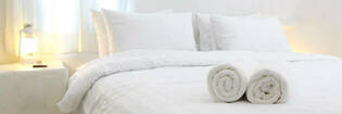 Folded towels on hotel bed